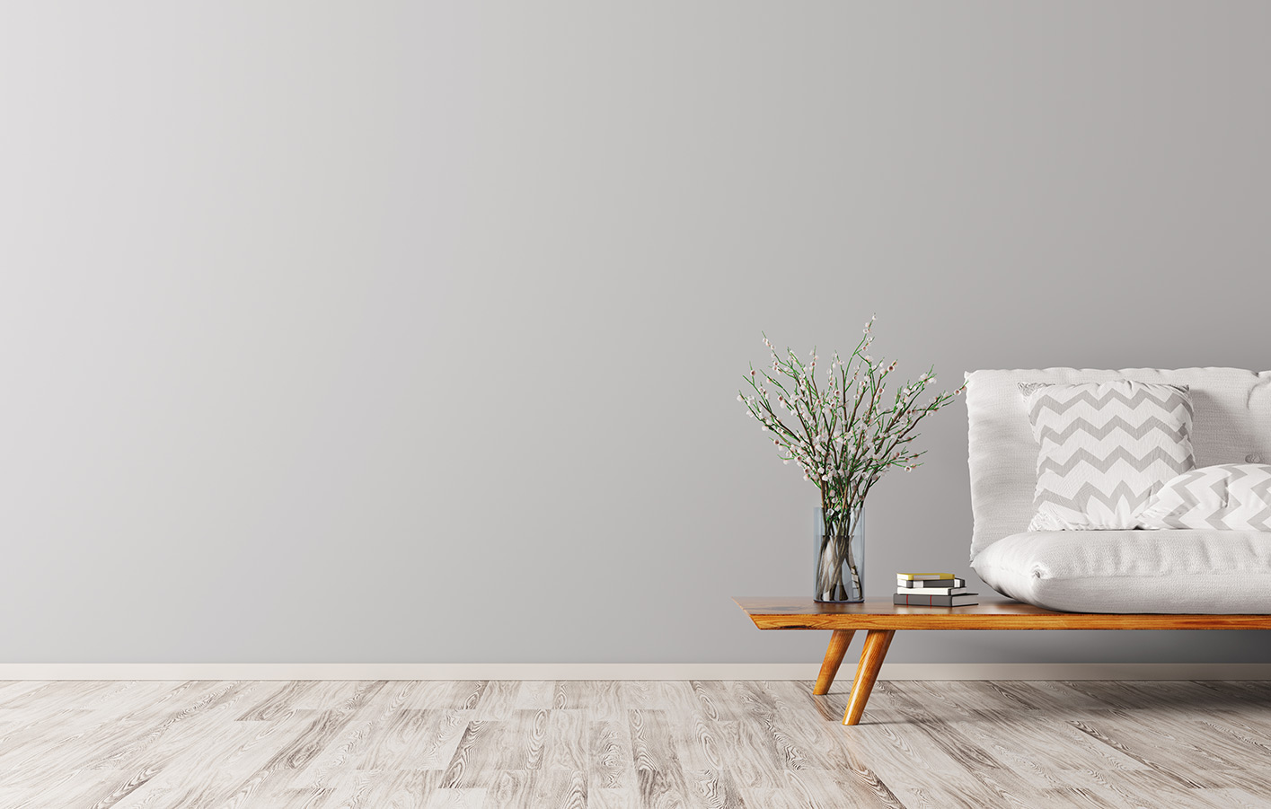 Designvinylboden von Holz Hahn aus Stockach. Designvinylboden in einem Raum mit einer grauen Wand und einer Couch plus einem Couchtisch.